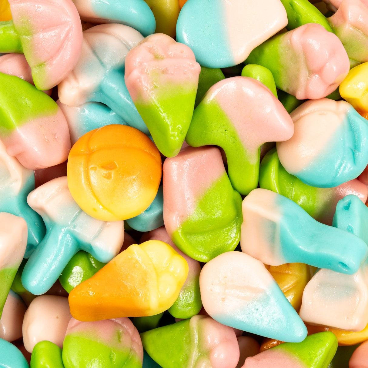 Assorted colorful candy pieces including green, pink, blue, and orange.
